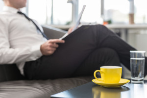 Business executive or lawyer sitting on his office couch
